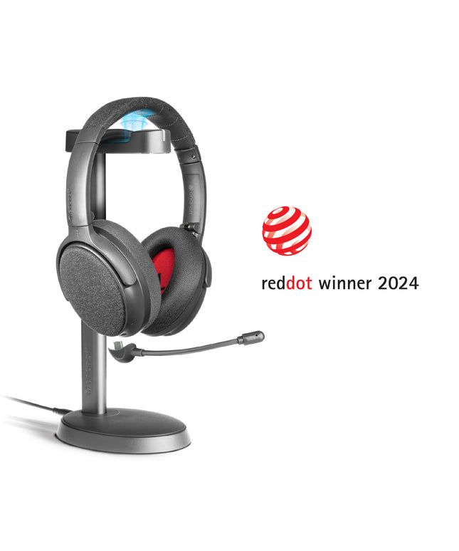 A midnight blue ONANOFF wireless ANC Bluetooth headphones with a detachable boom microphone sits on a stand, set against a clean white background. Winner of the RedDot Award 2024