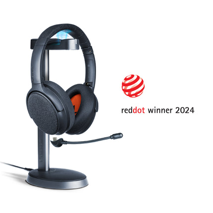 A midnight blue ONANOFF wireless ANC Bluetooth headphones with a detachable boom microphone sits on a stand, set against a clean white background. Winner of the RedDot Award 2024